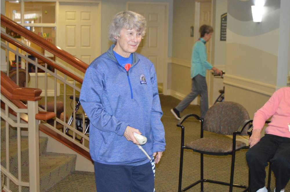 An alumna plays a game of Wii Bowling.